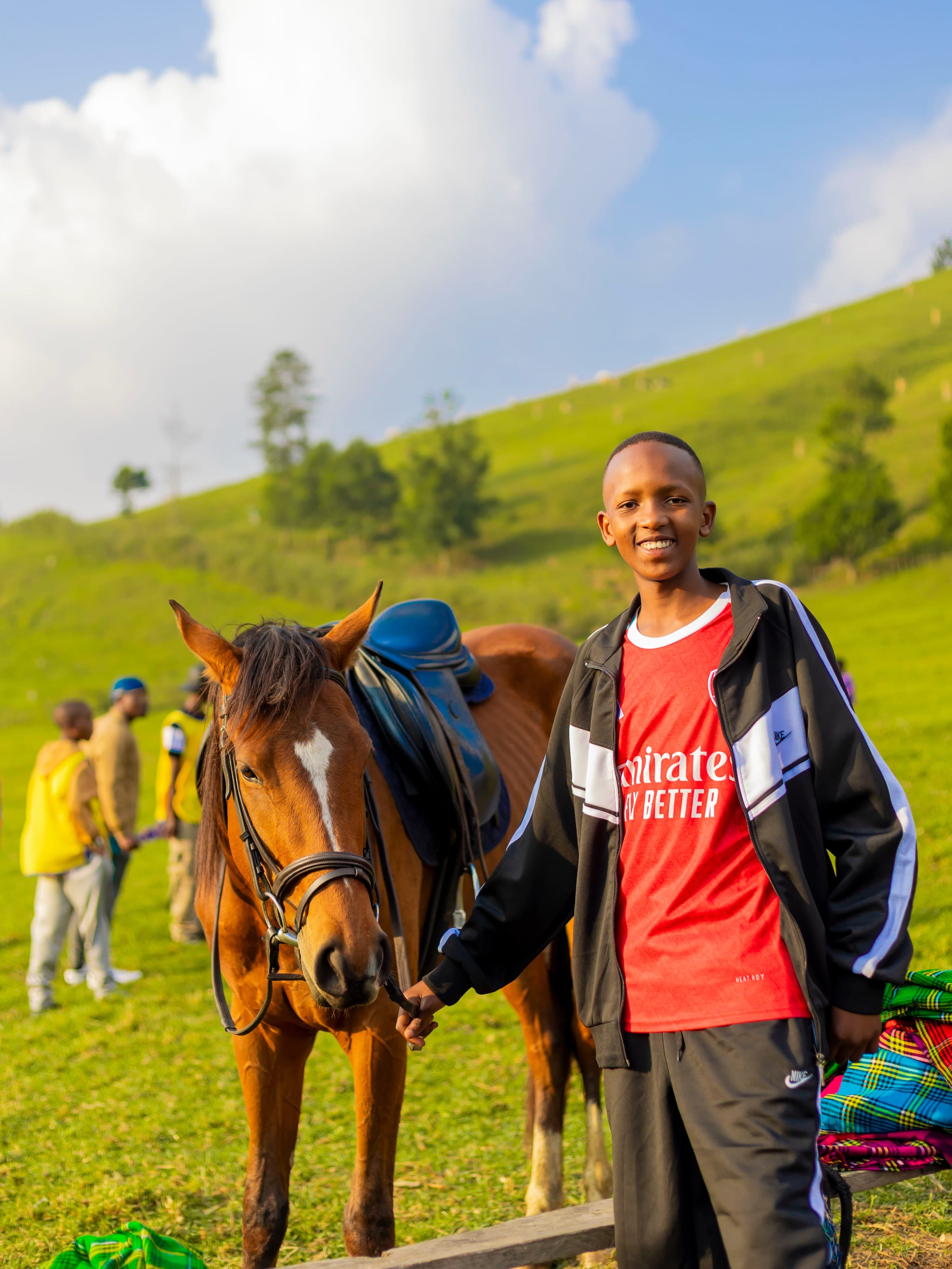 A Tamayuz Summer Camp student standing with a horse