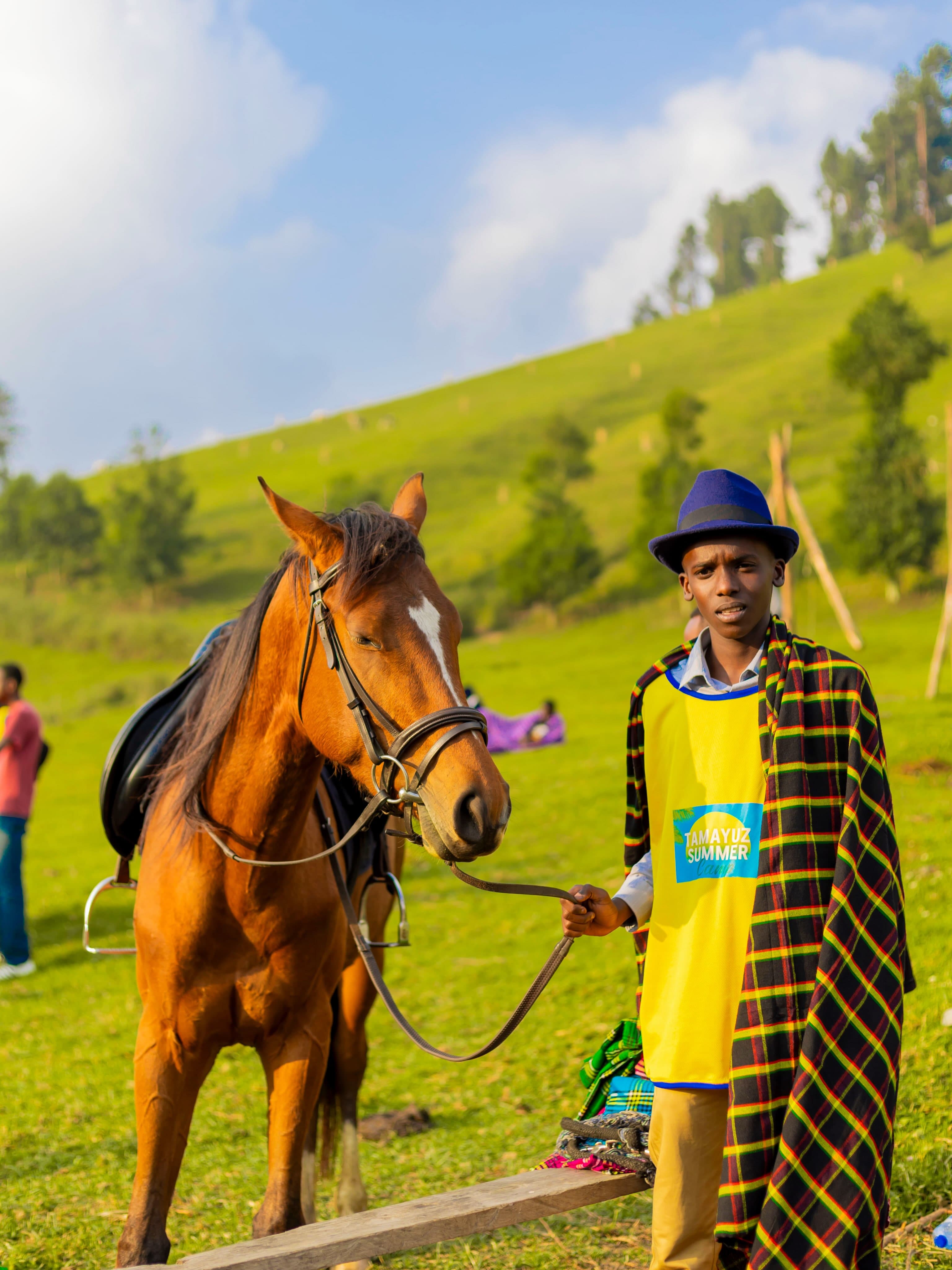 A Tamayuz student on horseback in the hills during Tamayuz Summer Camp