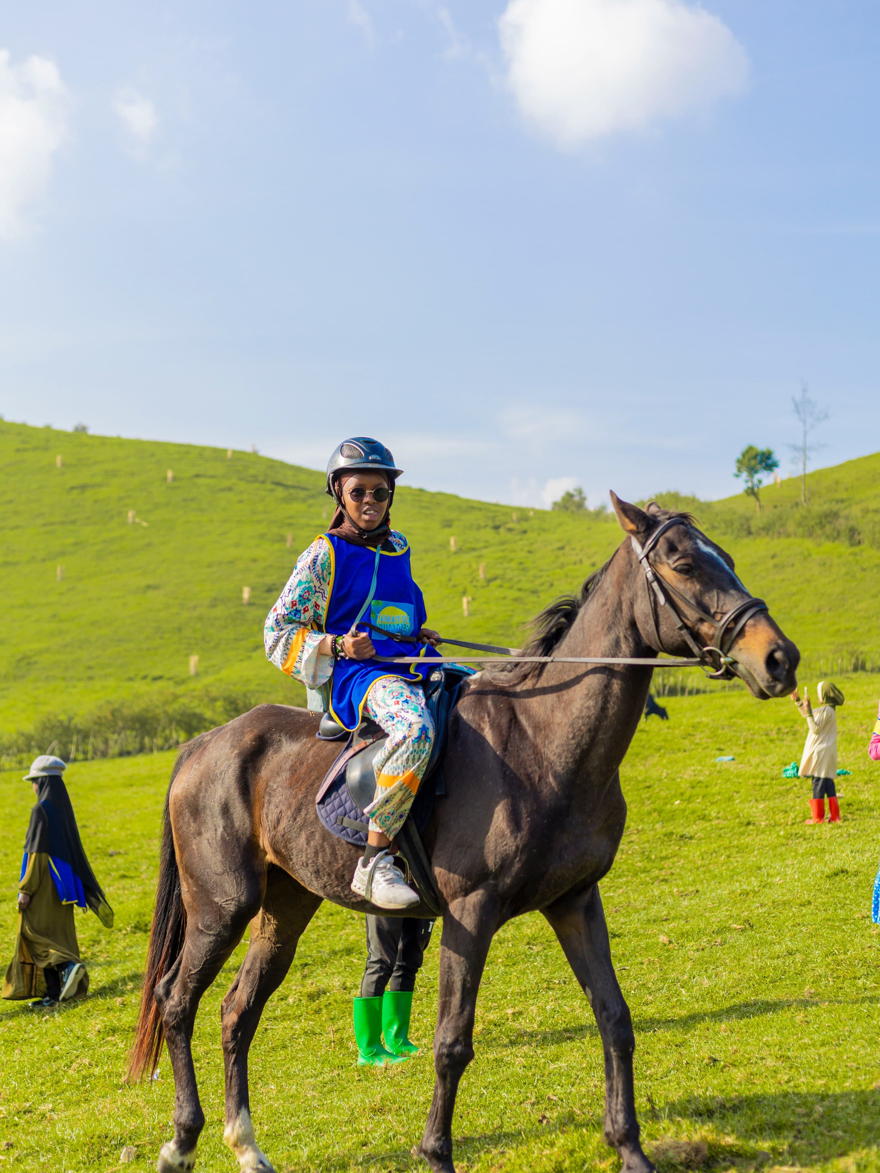 A Tamayuz Summer Camp student on horseback, smiling
