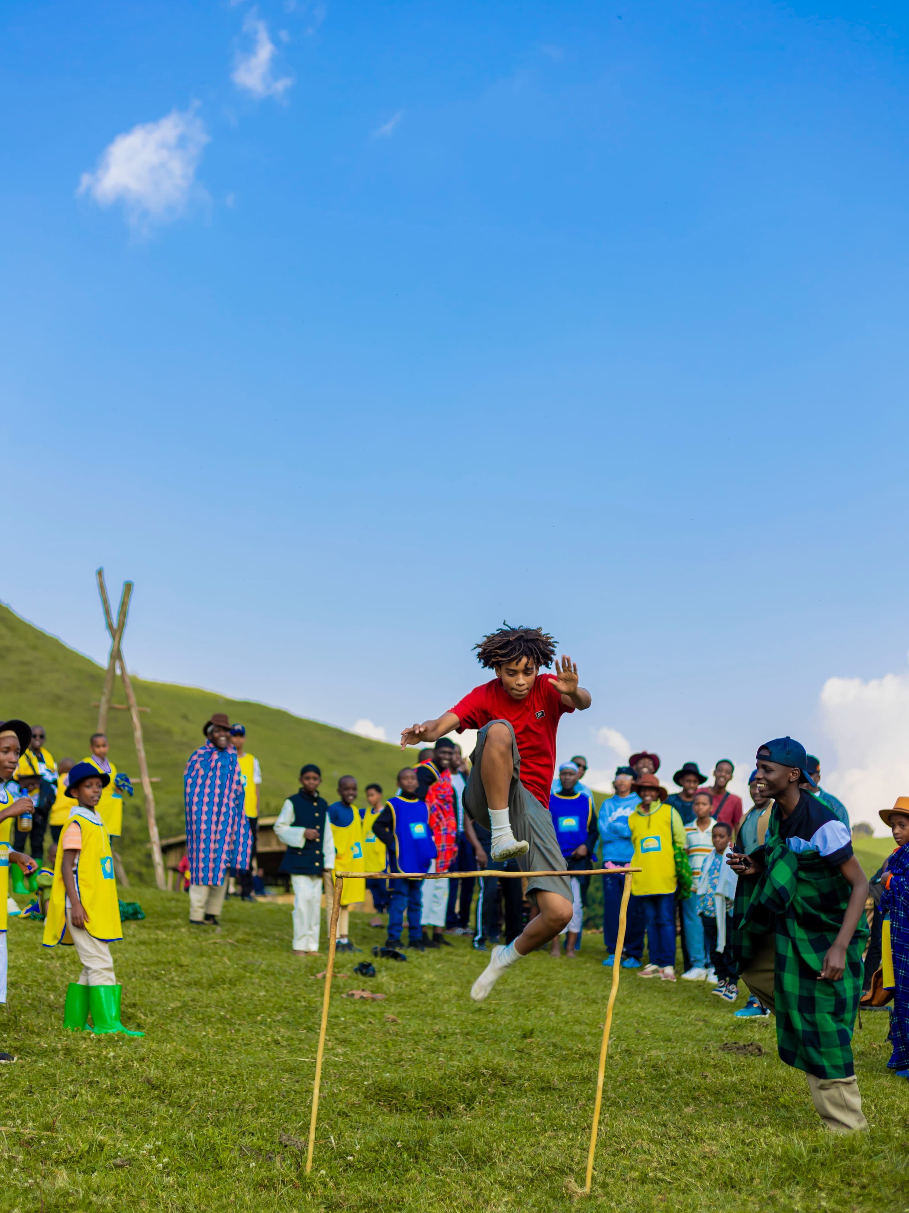 A Tamayuz Summer Camp student mid-jump over a hurdle game